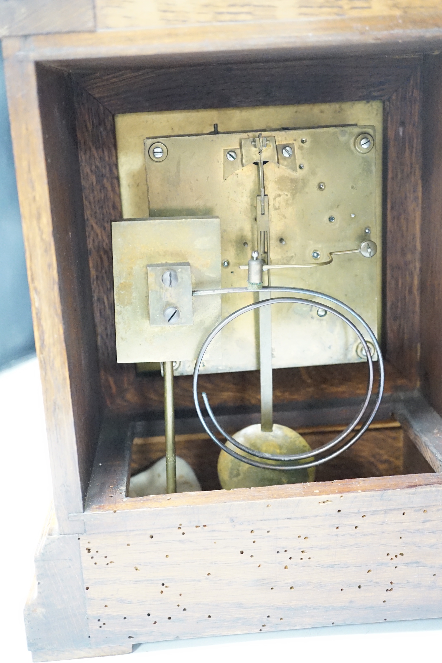 An Edwardian carved oak mantel clock with engraved dial, 33cm high